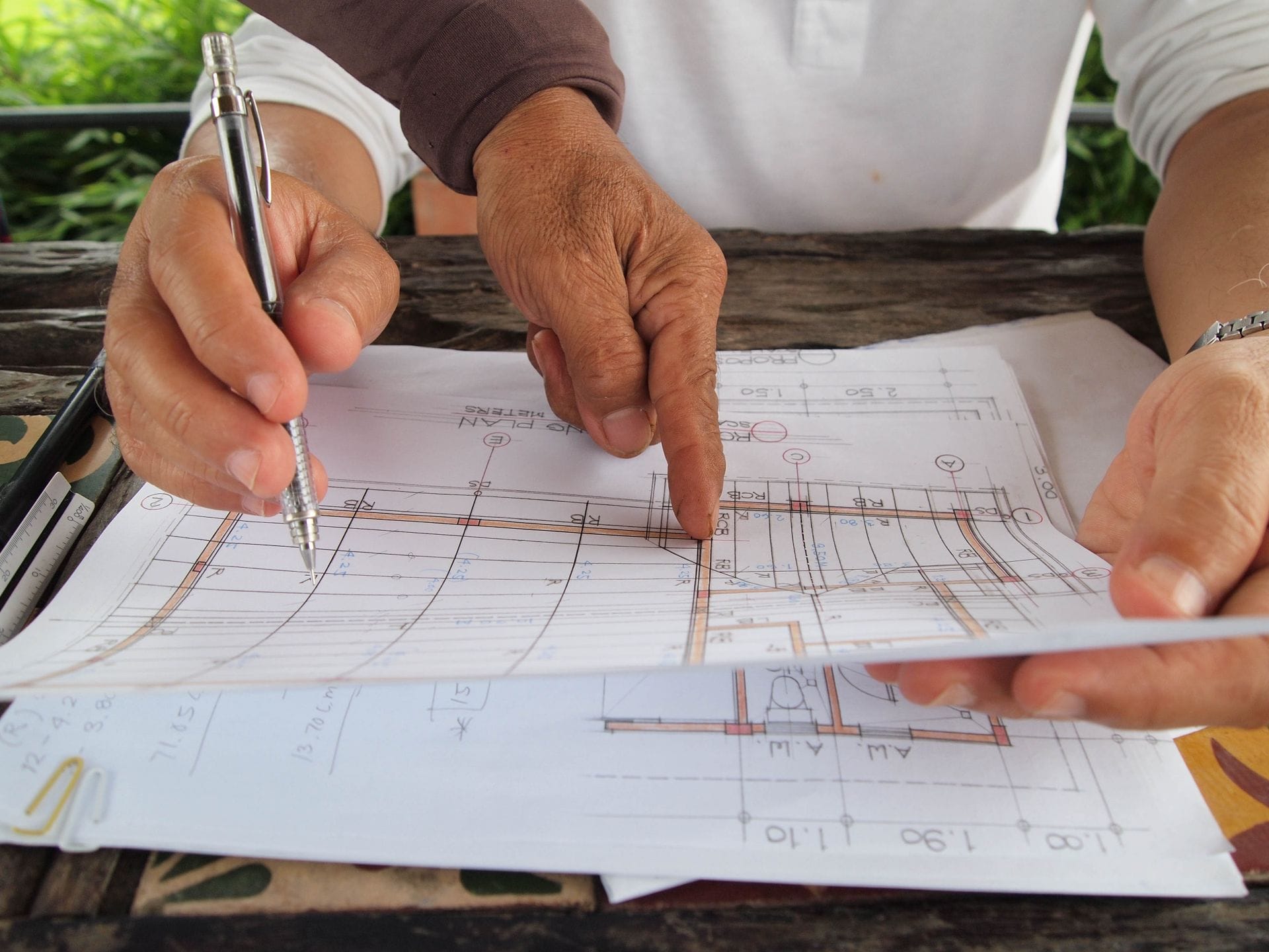 Técnicos calculando la mejora energética de un edificio sobre planos