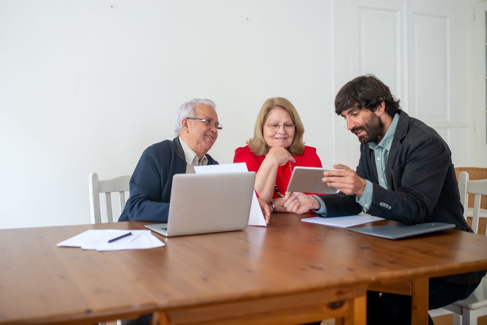 Un matrimonio mayor revisa con un técnico la documentación de la obra de accesibilidad